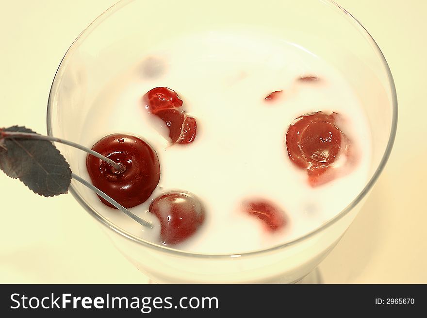 Yoghurt with a cherry on a yellow background