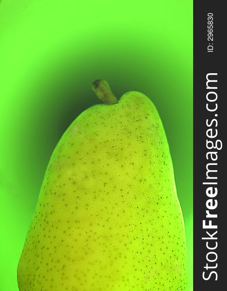 Green pear on a green background