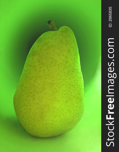 Green pear on a green background