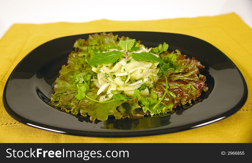 Vegetarian dish with cucumber and onion on a bed of salad. Vegetarian dish with cucumber and onion on a bed of salad