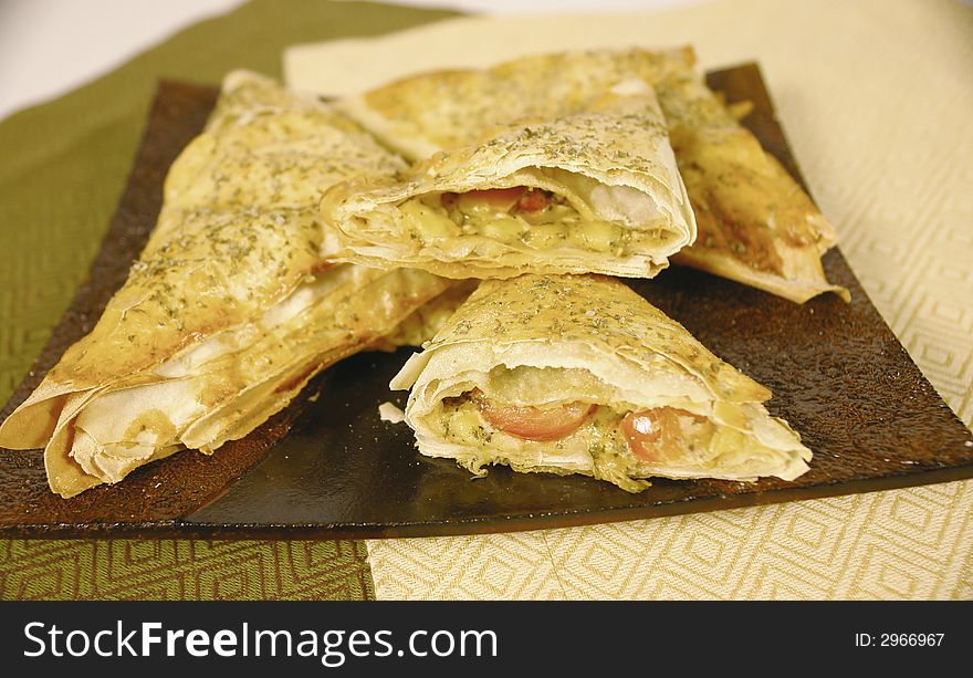 Baked dough pockets filled with edam cheese and cherry tomato