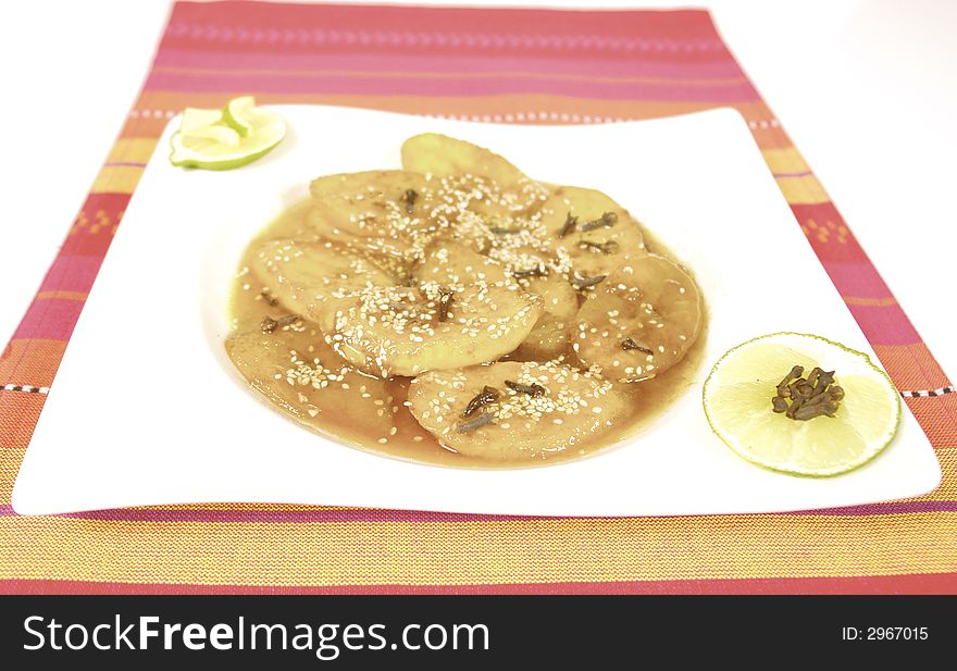 Banana or plantain served with a syrup and sesame seeds. Banana or plantain served with a syrup and sesame seeds