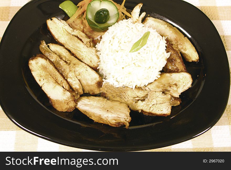 Chicken cut into pieces and served with rice. Chicken cut into pieces and served with rice