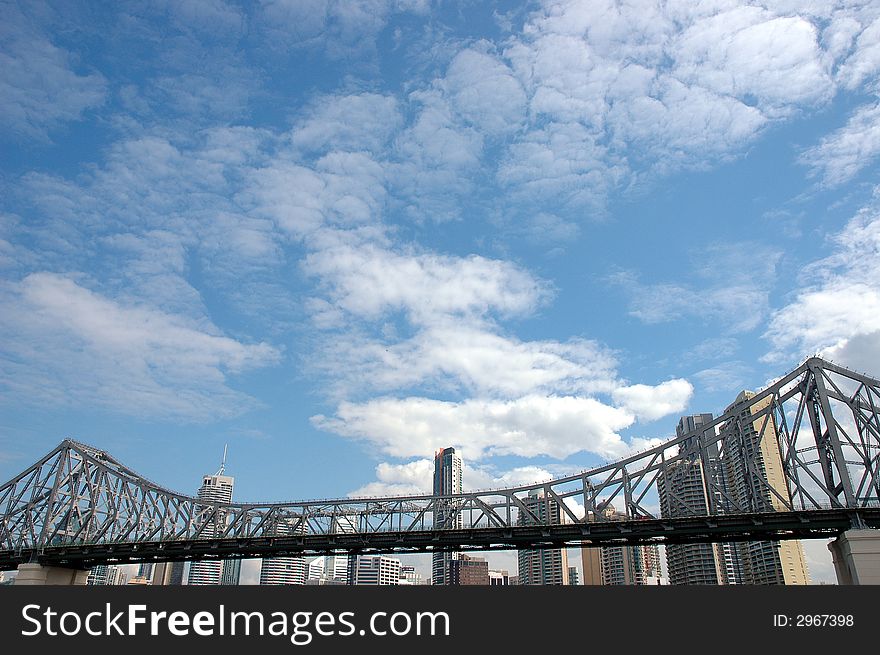 Brisbane Story bridge against blue sky and skyscrapers background