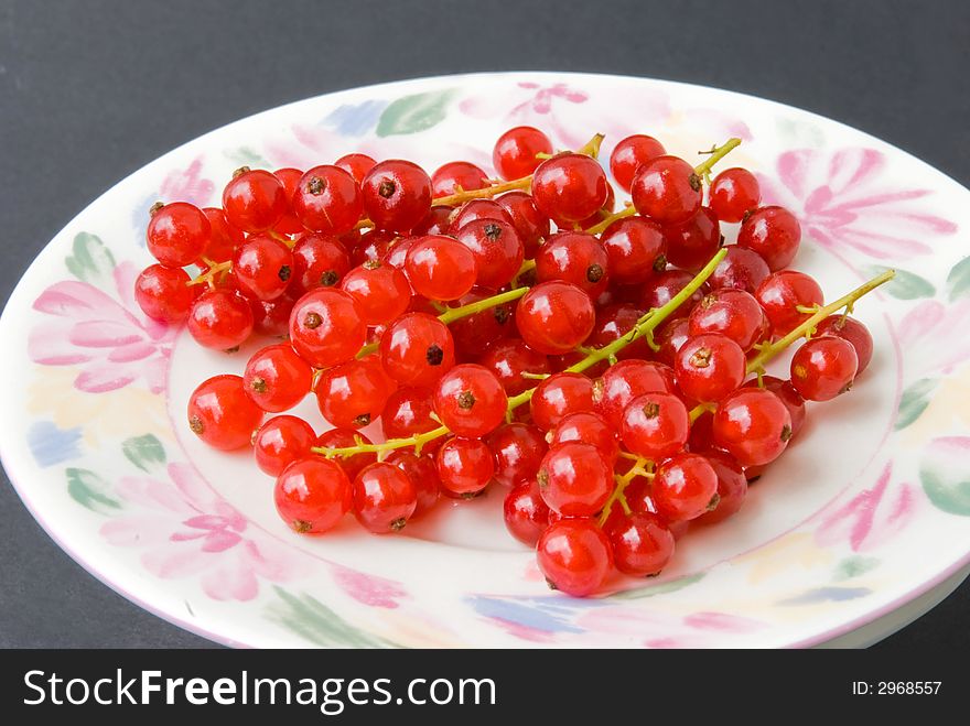 Red currant.on rhe plate-shot. Red currant.on rhe plate-shot.