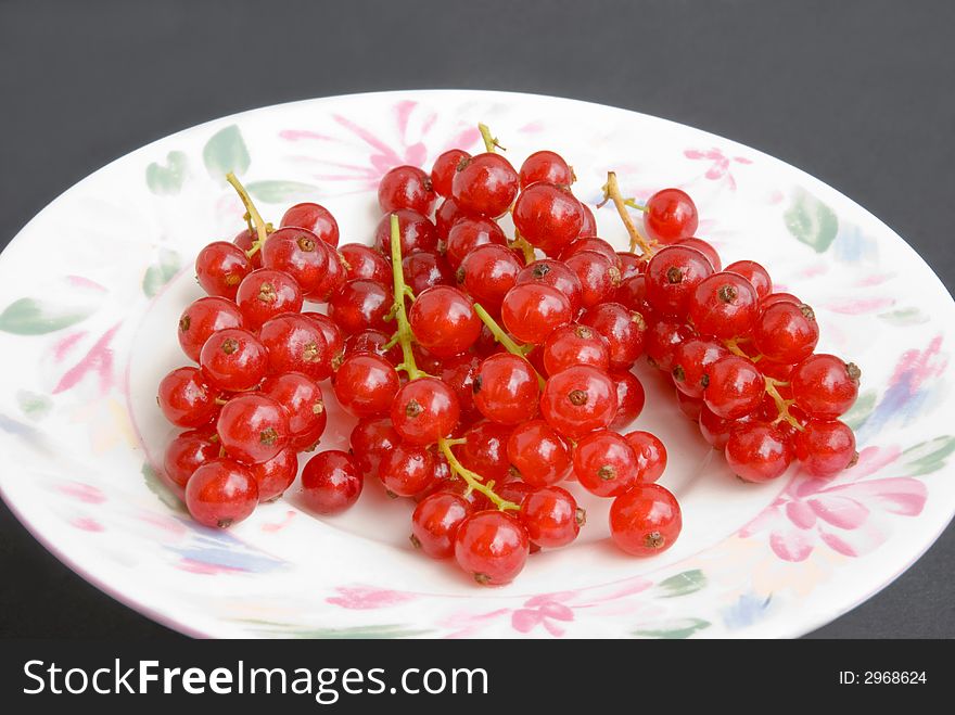 Red currant.on rhe plate-shot. Red currant.on rhe plate-shot.