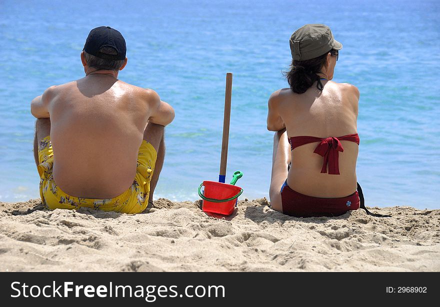 A couple on the sand beach. A couple on the sand beach