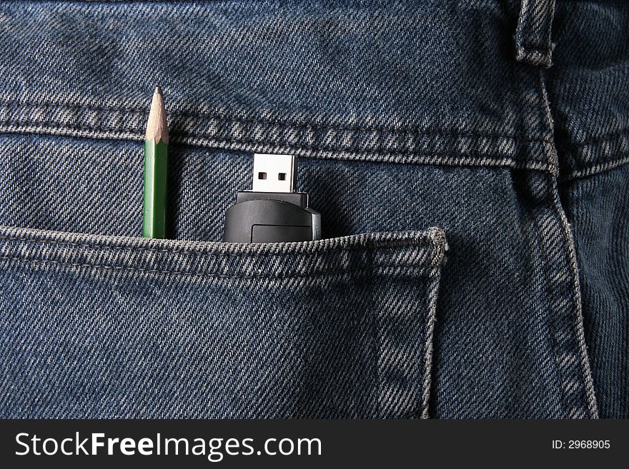 A pencil and USB memory in a trousers pocket. A pencil and USB memory in a trousers pocket