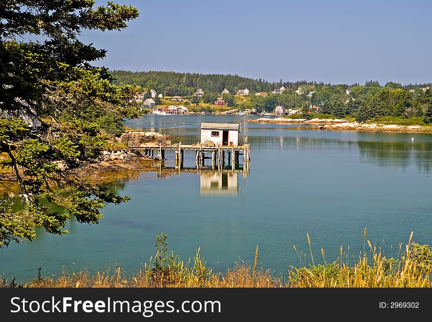 An view of a privately owned fishing shack and dock near a scenic fishing village on beautiful and quaint Swans Island, Maine. An view of a privately owned fishing shack and dock near a scenic fishing village on beautiful and quaint Swans Island, Maine.