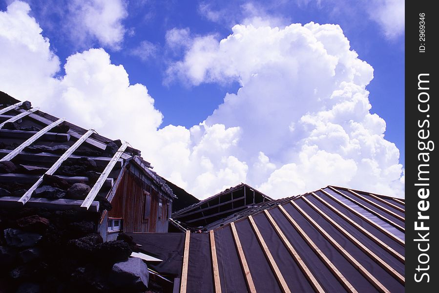 A mountain hut near the summit of Mount Fuji with billowing clouds. A mountain hut near the summit of Mount Fuji with billowing clouds