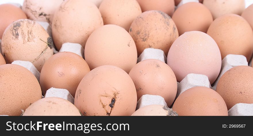 Many brown eggs in the paper case