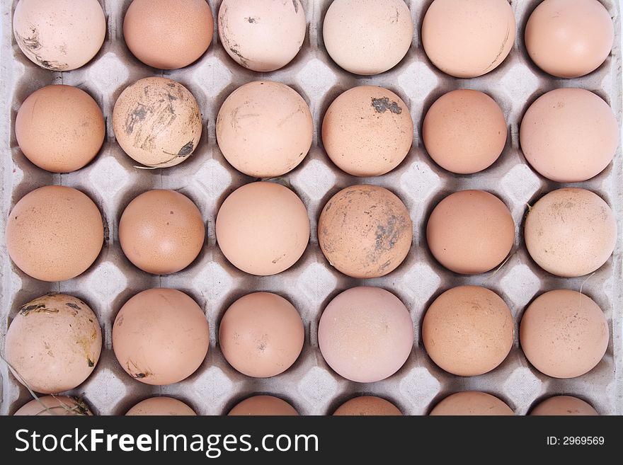 Many brown eggs in the paper case