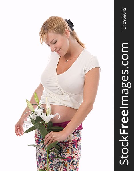 The attractive pregnant woman holds a liliy in hands. The attractive pregnant woman holds a liliy in hands