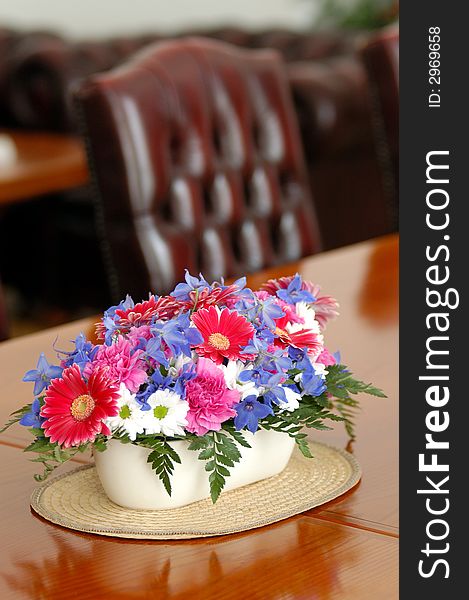 A table with seets decorated by flowers. A table with seets decorated by flowers
