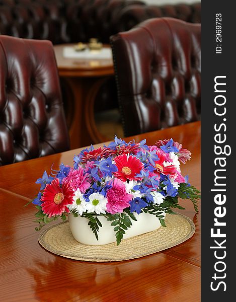 A table with seets decorated by flowers. A table with seets decorated by flowers