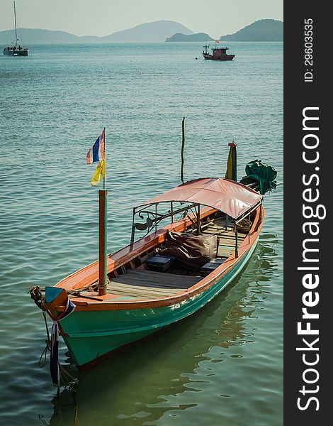 A green long tail boat at panwa cape, phuket