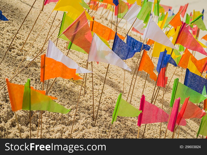 Many of paper flag put in a heap of sand to celebrate a temple. Many of paper flag put in a heap of sand to celebrate a temple