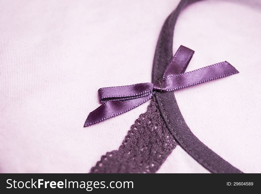 Pink cloth with purple silk bow-knot background. Pink cloth with purple silk bow-knot background