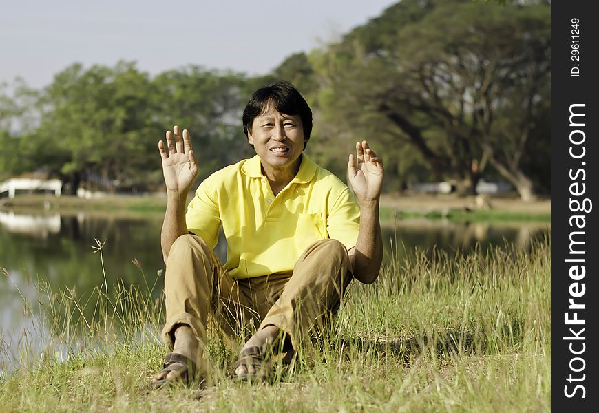 Portrait of a happy asian man in summer park