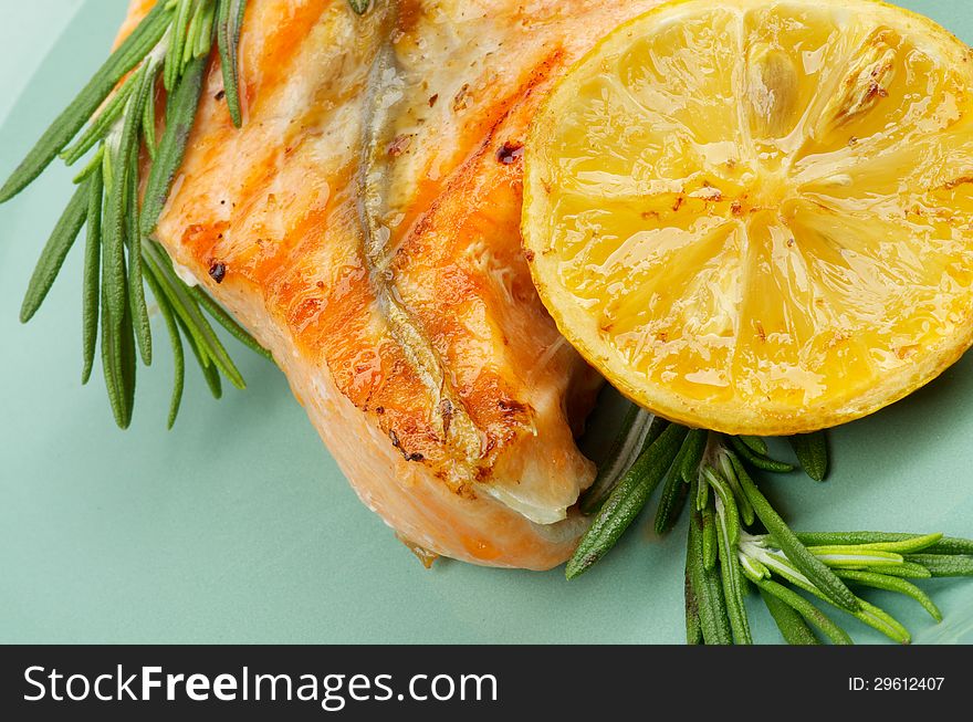 Fillet of Grilled Salmon with Rosemary and Lemon closeup on Green Plate