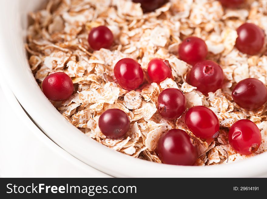 Flakes with cranberries on the white bowl. Flakes with cranberries on the white bowl