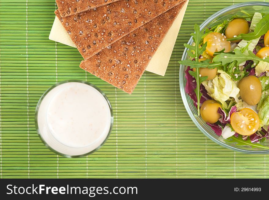 Vegetable salad with diet biscuits and glass of yogurt top view. Vegetable salad with diet biscuits and glass of yogurt top view