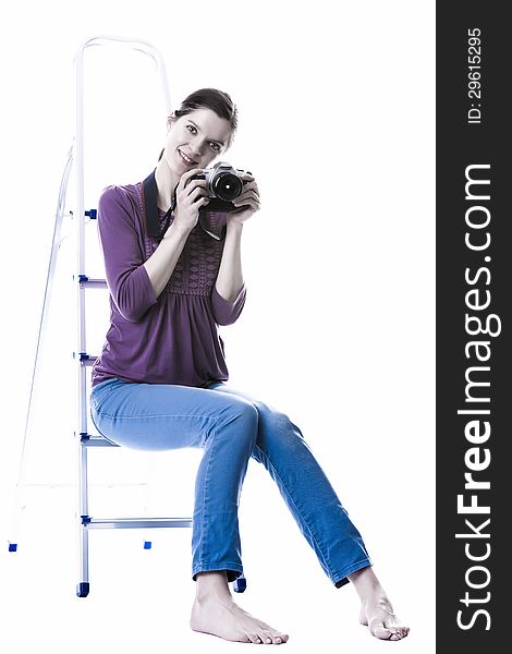 Beautiful young woman with camera, sitting on the ladder, barefoot, isolated on white background. Beautiful young woman with camera, sitting on the ladder, barefoot, isolated on white background