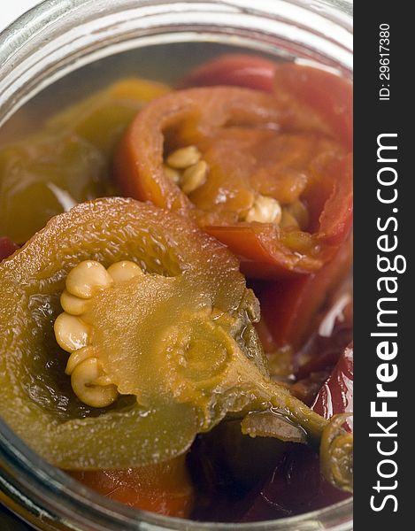 Hot cherry peppers red and green appetizer in glass jar