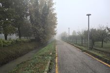 Bike Lane On A Foggy Day Next To A Trench With Water On A Foggy Day In The Italian Countryside Stock Photos