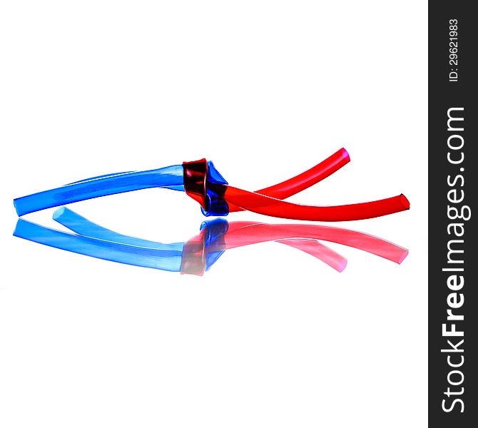 Two red and blue PVC Hoses tied together with shadow reflection