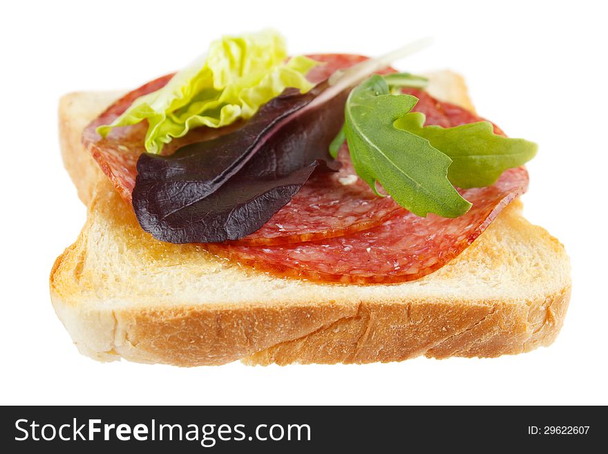Toast with mettwurst cold cuts and different lettuce leaves , isolated on white. Toast with mettwurst cold cuts and different lettuce leaves , isolated on white
