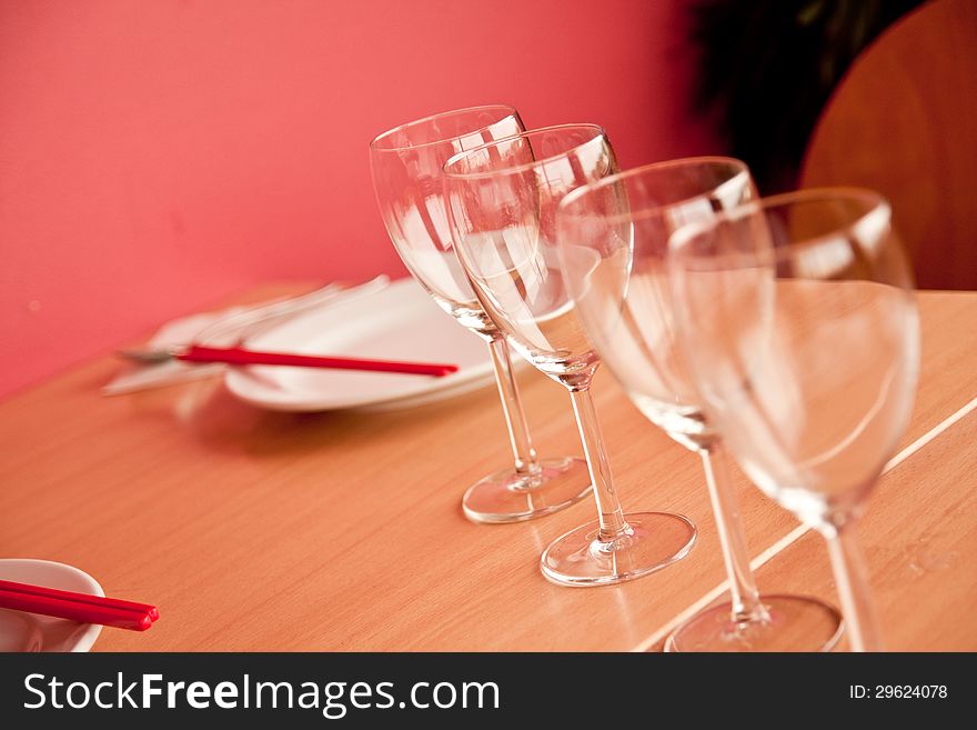 Dinner table with plate, spoon, and wine glass. Dinner table with plate, spoon, and wine glass.