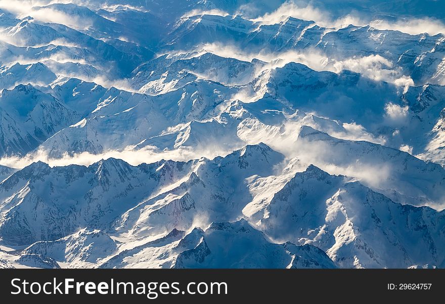 View of blue snow-covered Pyrenees mountains from fly. View of blue snow-covered Pyrenees mountains from fly