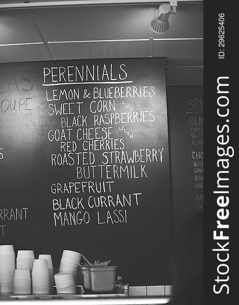 Black and white chalkboard image of the inside of an ice cream shop, handwritten in white chalk, ice cream flavors. Black and white chalkboard image of the inside of an ice cream shop, handwritten in white chalk, ice cream flavors