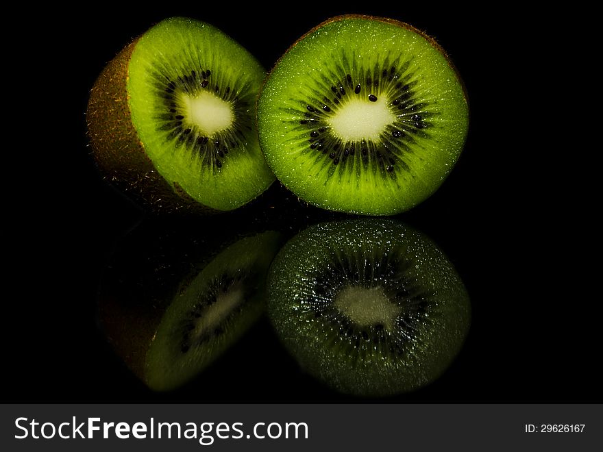 A fresh and juicy kiwi cut into halves and ready to be served. A fresh and juicy kiwi cut into halves and ready to be served.