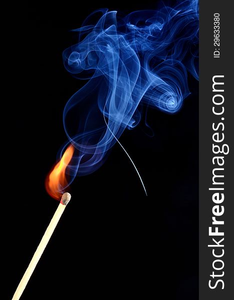 The burning match in the black background