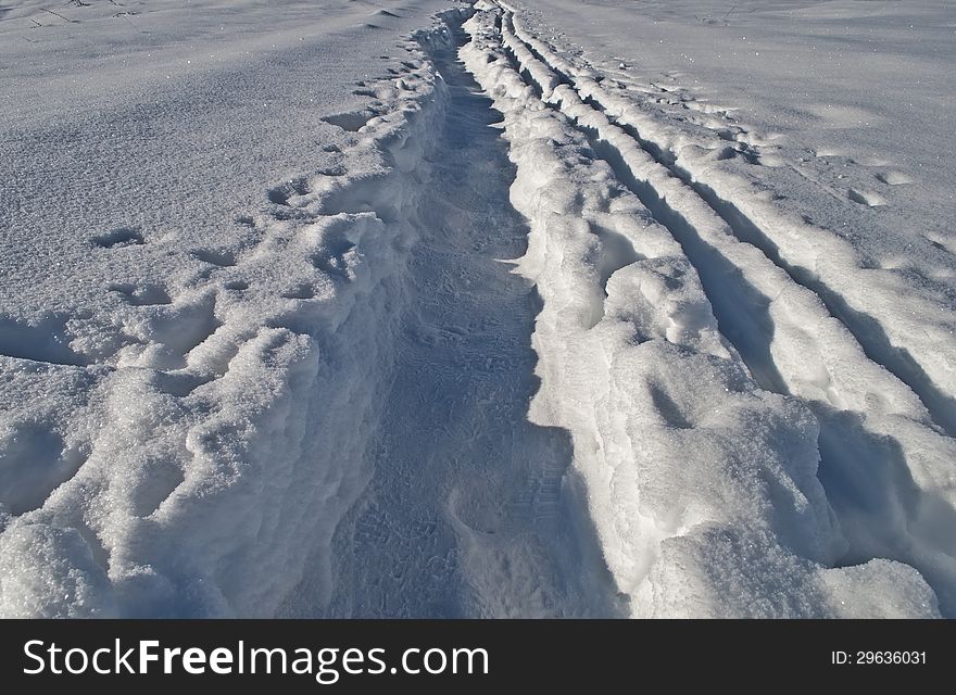 Close up of footpath in snow between snowdrifts