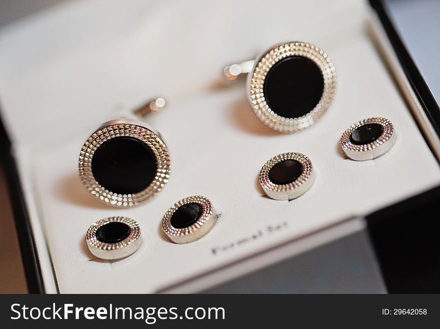 Cuff links and buttons for a tuxedo in a box