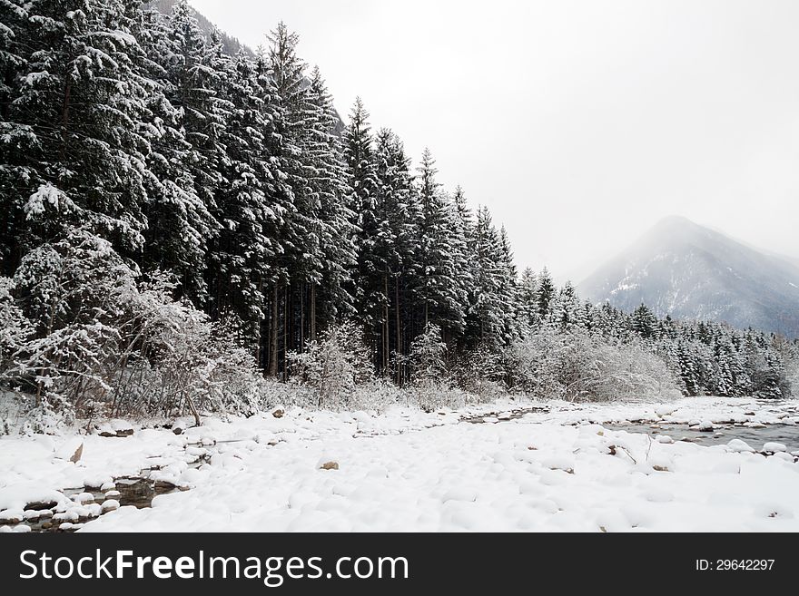 A winter landscape with river and mountain in the background. A winter landscape with river and mountain in the background