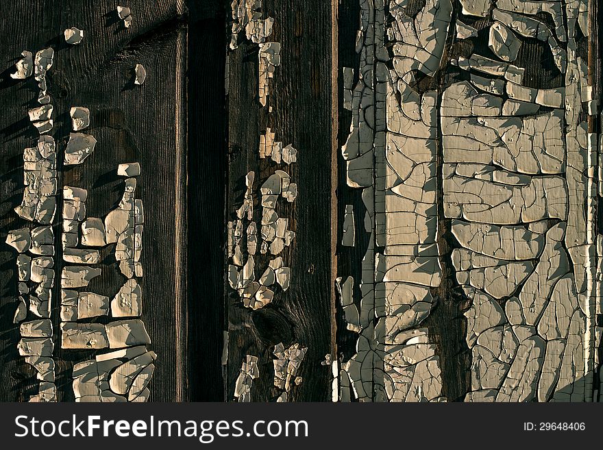 Old wooden wall with old peeled-off paint as a background