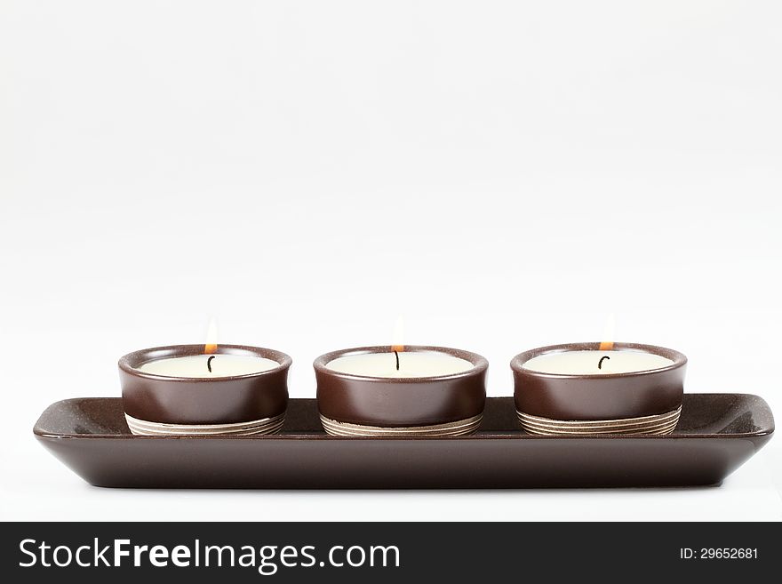 Three burning candles isolated on white