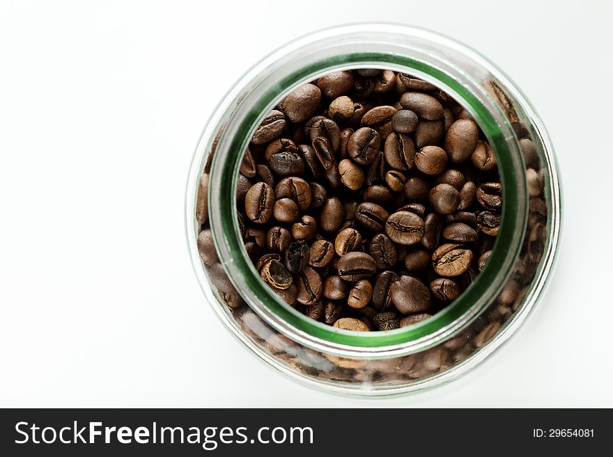 Coffee beans in a bottle on white background. Coffee beans in a bottle on white background