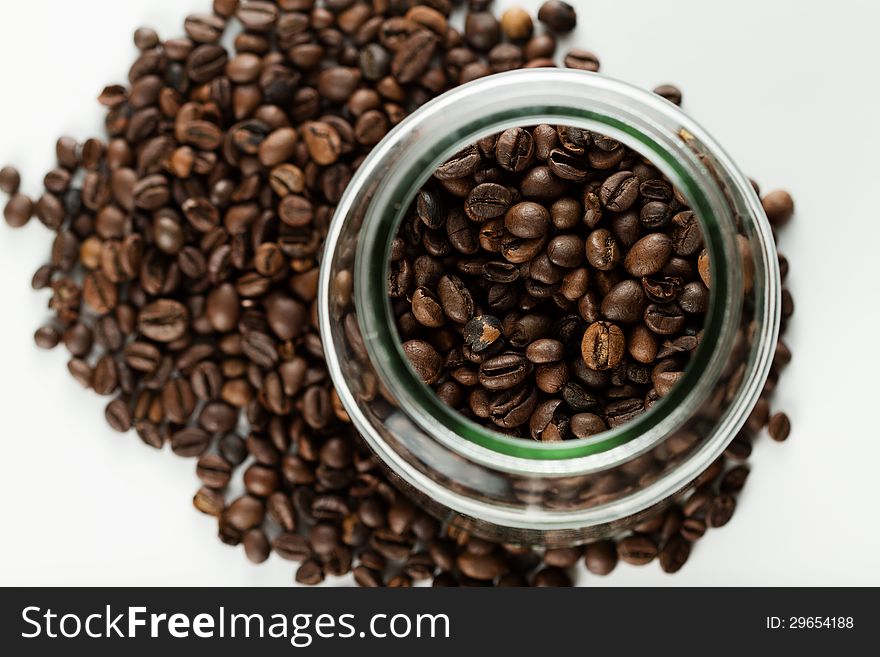 Coffee beans in a bottle on white background. Coffee beans in a bottle on white background