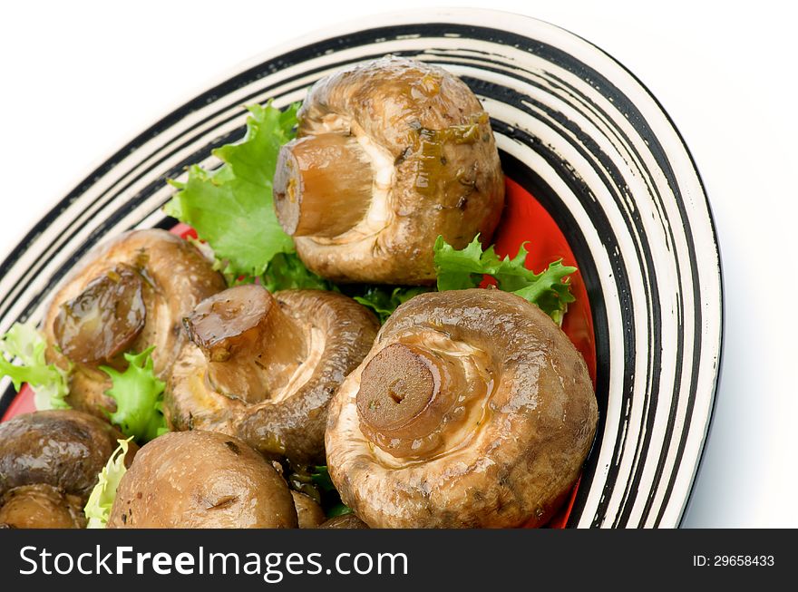 Big Roasted Champignon Mushrooms with Greens on Plate cross section  on white background. Big Roasted Champignon Mushrooms with Greens on Plate cross section  on white background