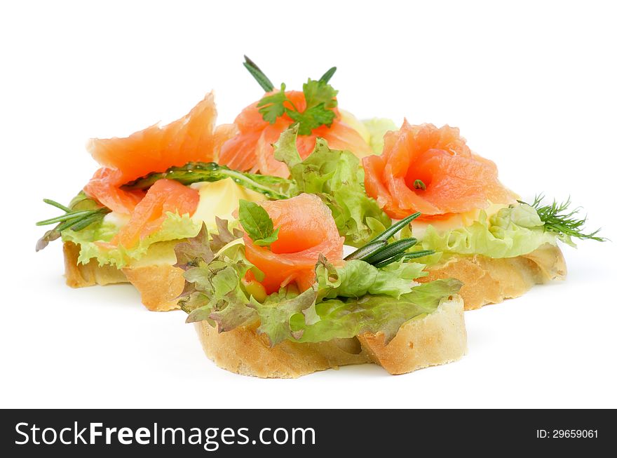 Arrangement of Delicious Smoked Salmon Appetizers with Lettuce, Rosemary, Cucumber and Cheese Sauce on white background