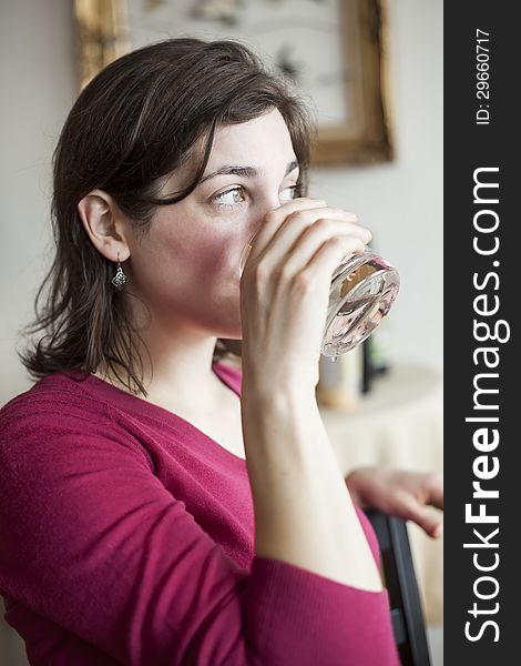 Beautiful Young Woman Drinks A Glass Of Water