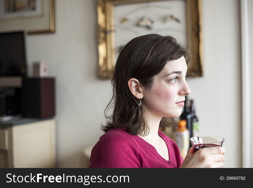 Young Woman with Beautiful Green Eyes Drinking Wine