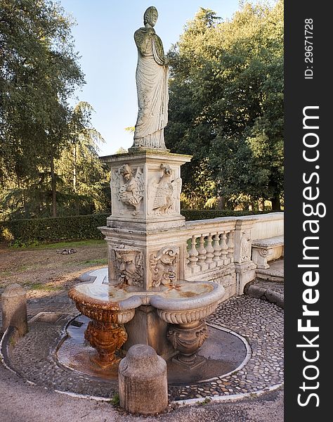 Roman fountains, ancient statue in the park of the Villa Borghese, Rome, Italy