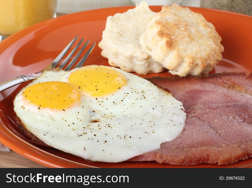 Slice of ham with fried eggs on a plate. Slice of ham with fried eggs on a plate