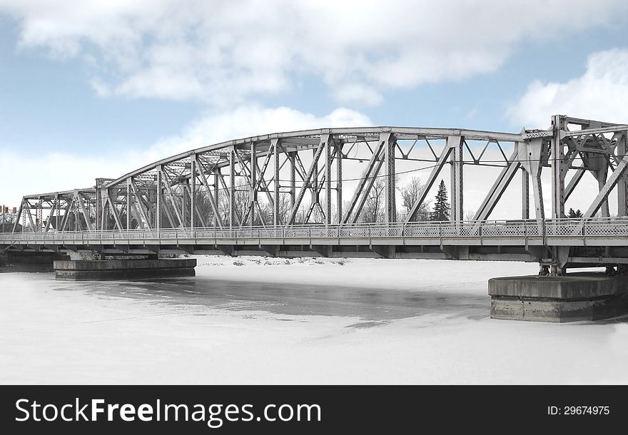 Girder bridge over a frozen river.